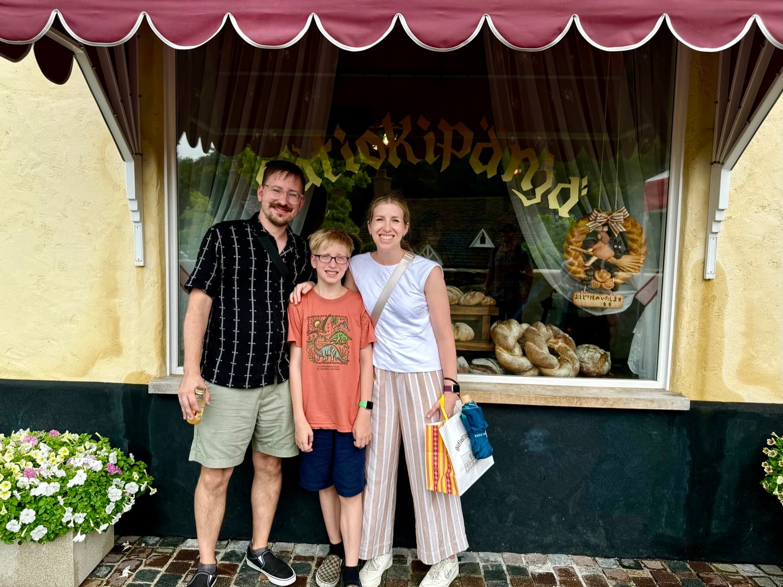 Family in front of Kiki's bakery at Ghibli Park